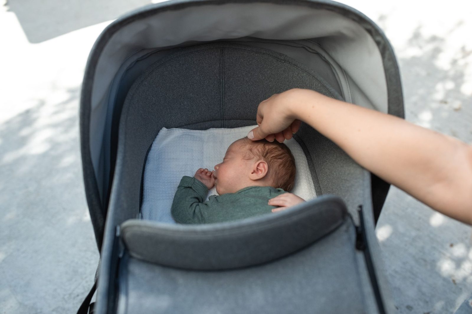 Newborn baby lying in a carrycot